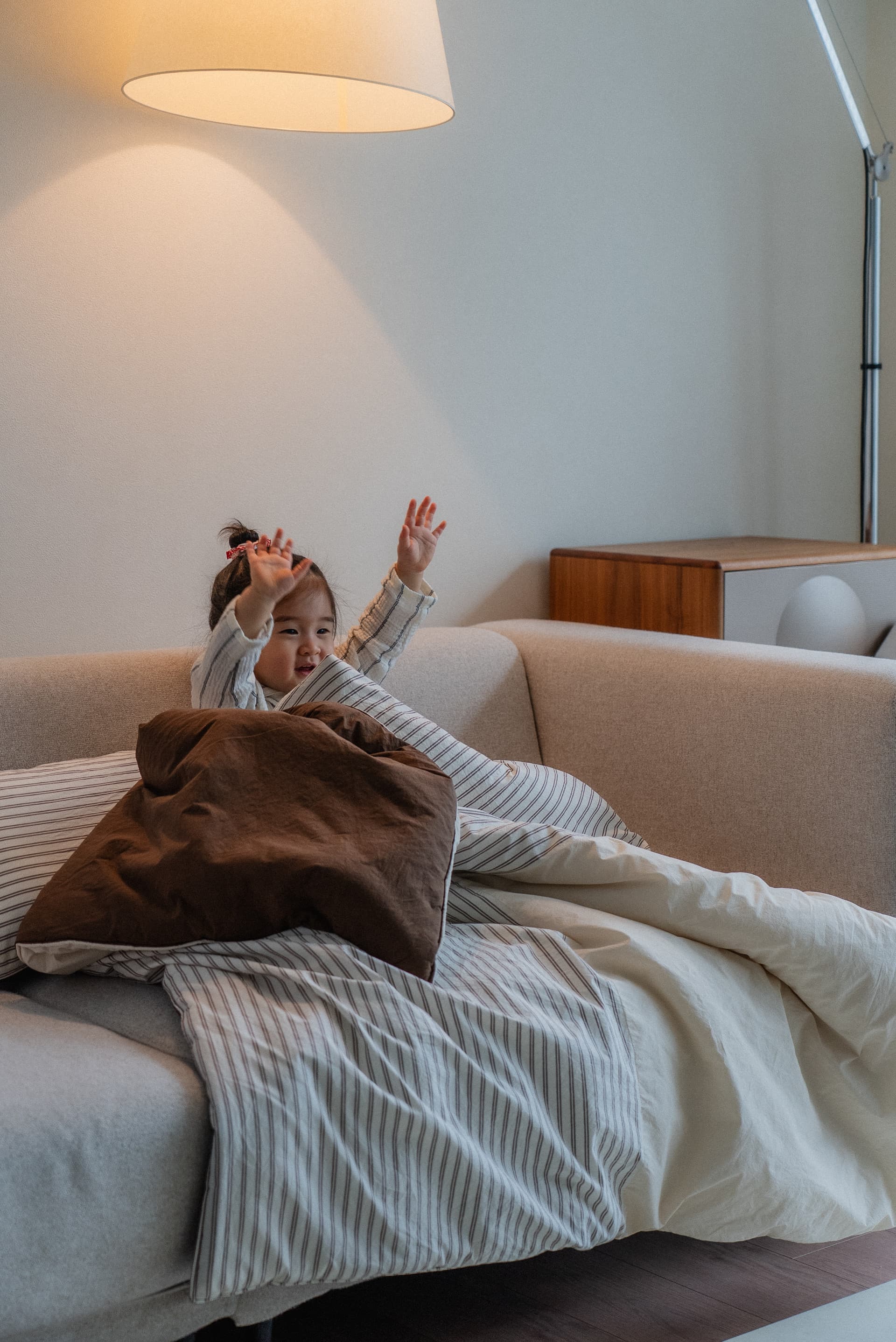Toddler playing on a sofa.
